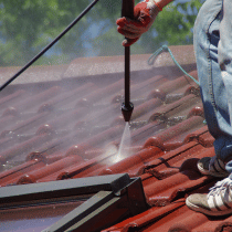 roof cleaner using pressure washer on tile roof